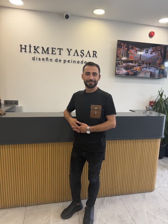 Hikmet Yaşar Kuaför resepsiyonu ve logo duvarı